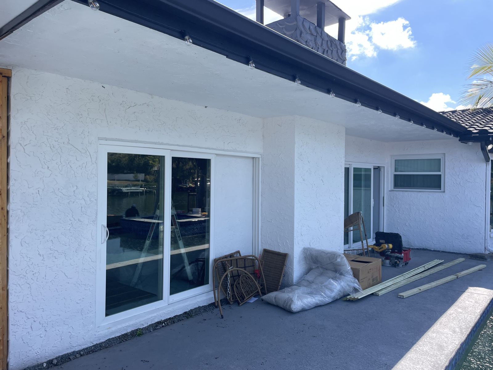 White waterfront home before repaint