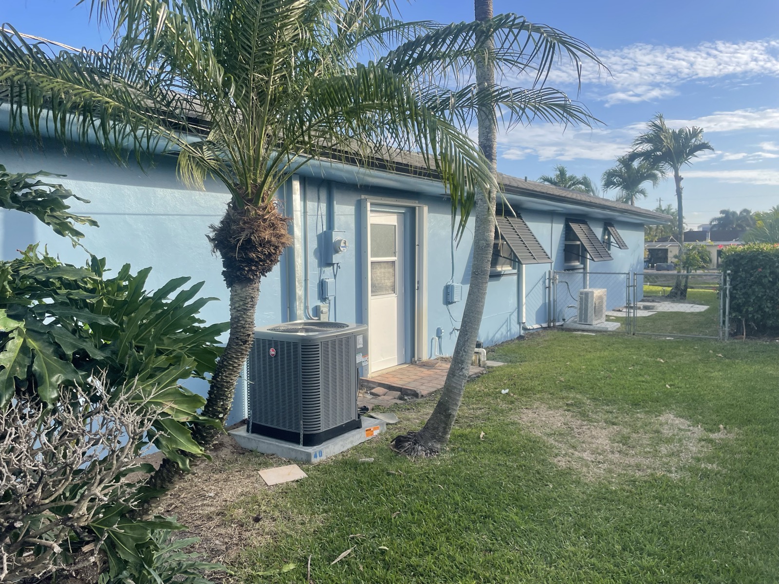 Light blue ranch home exterior after fresh repaint