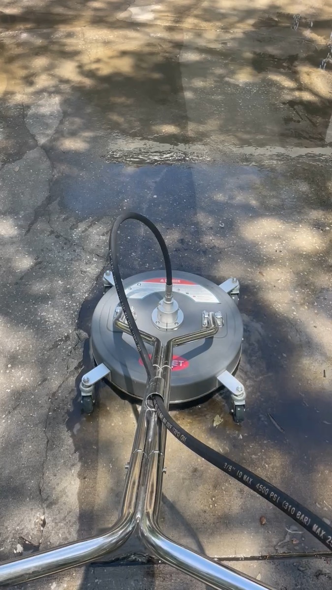Surface cleaner power washing a driveway — video