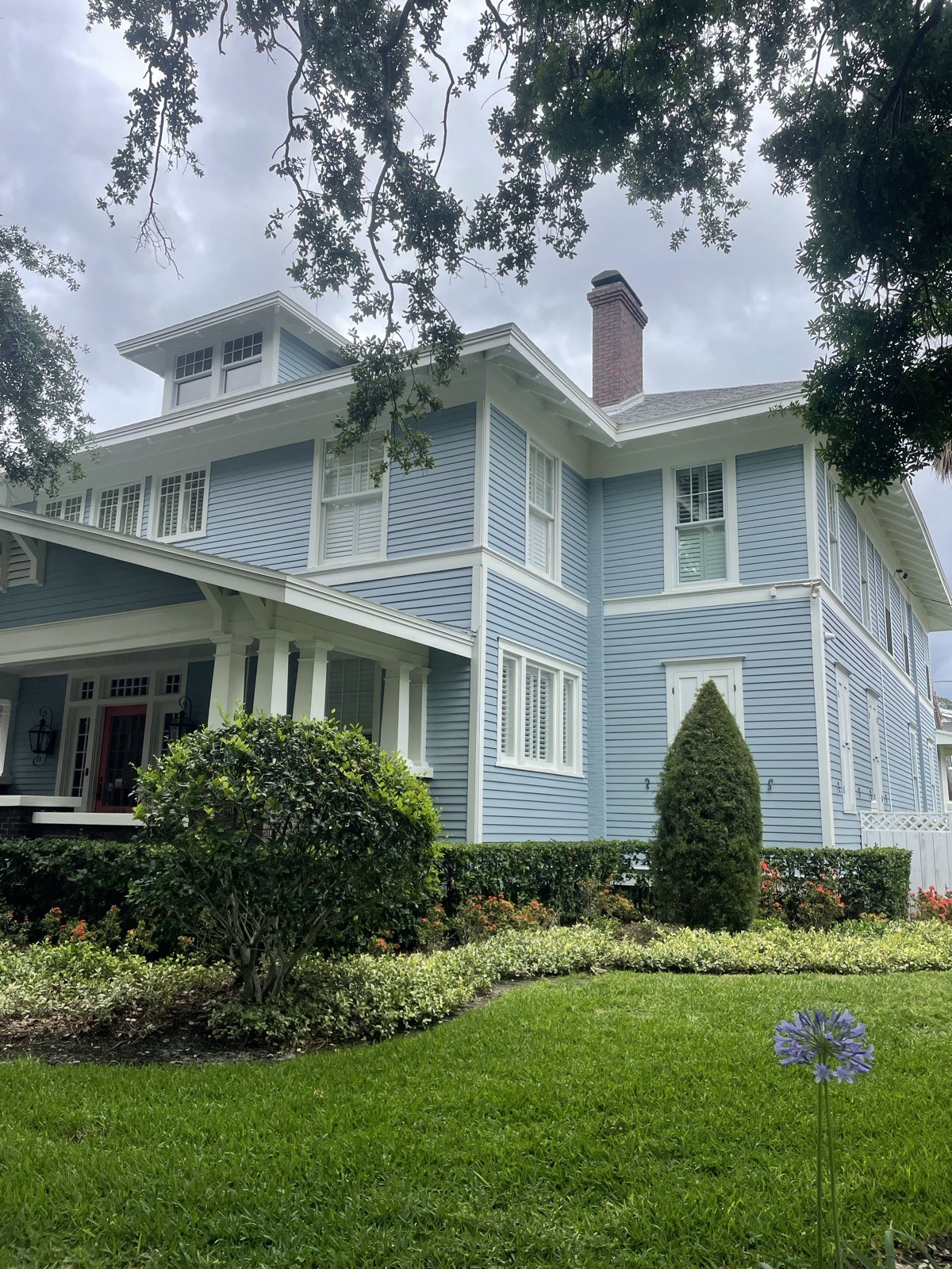 Two-story blue craftsman home with white trim