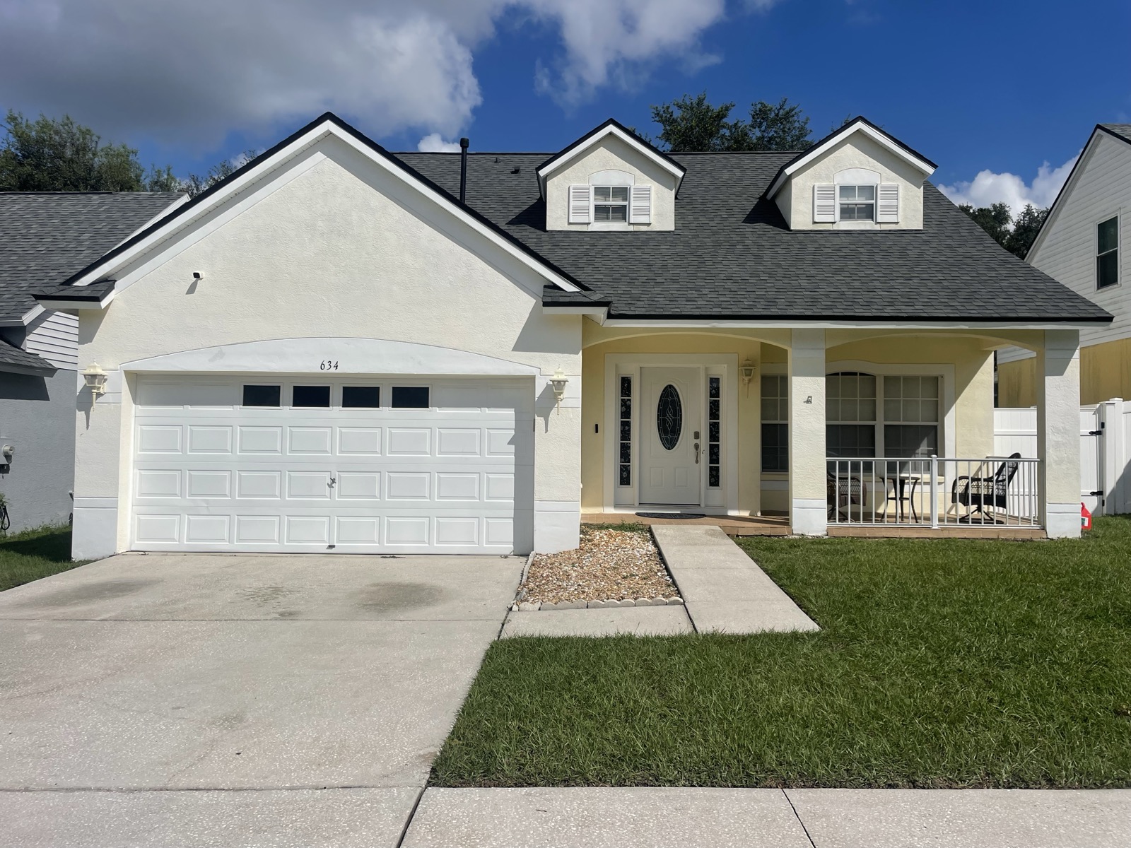 Cream two-story home before repaint