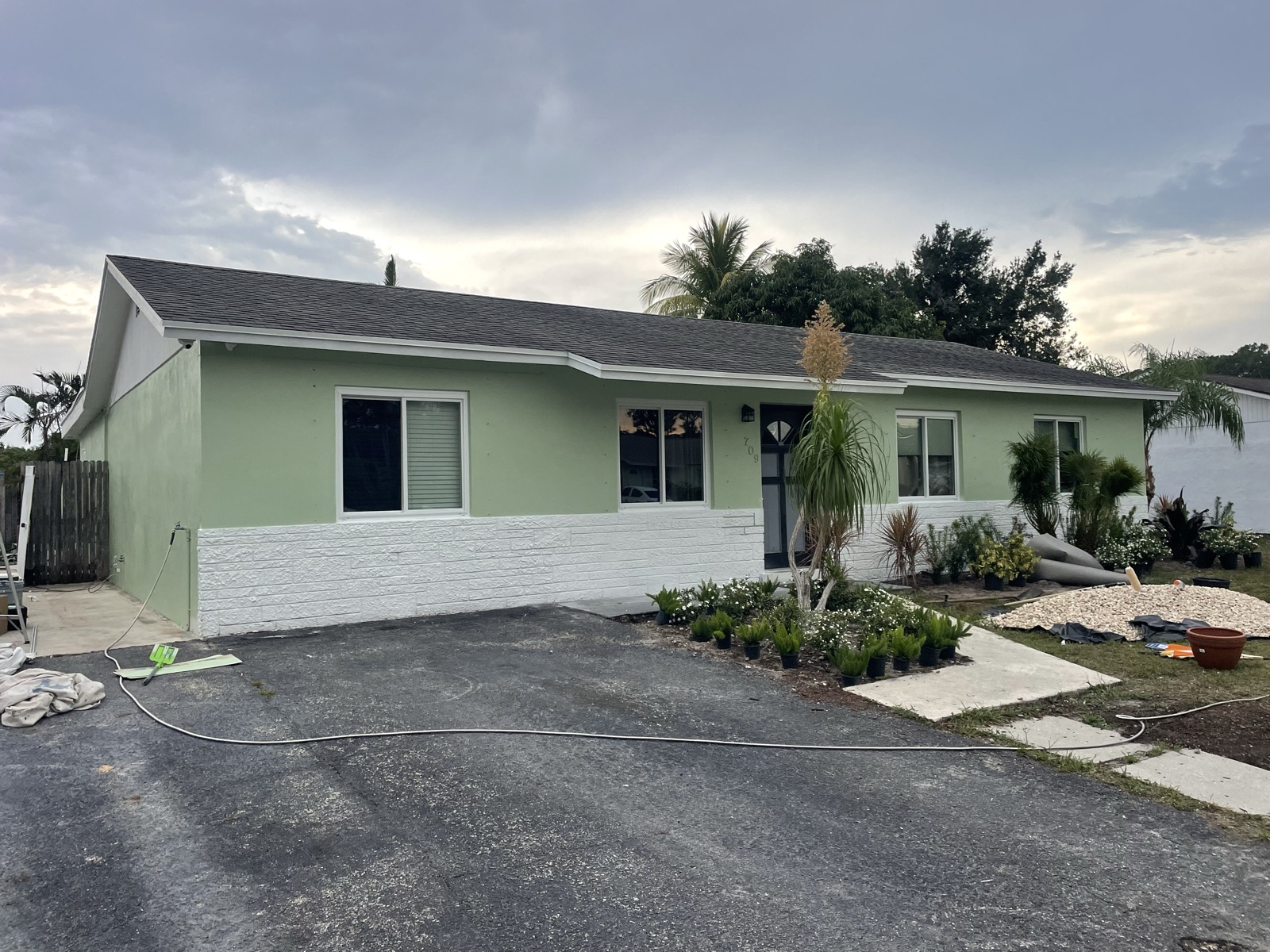 Green ranch home with fresh two-tone exterior paint