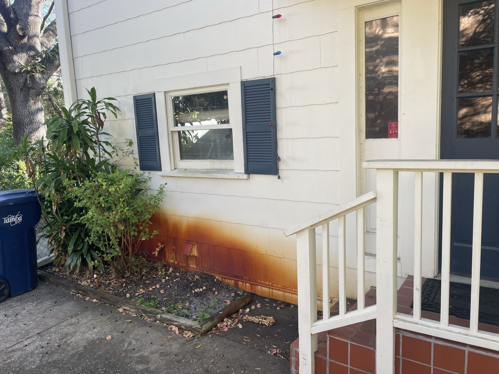 Rust-stained siding before power washing