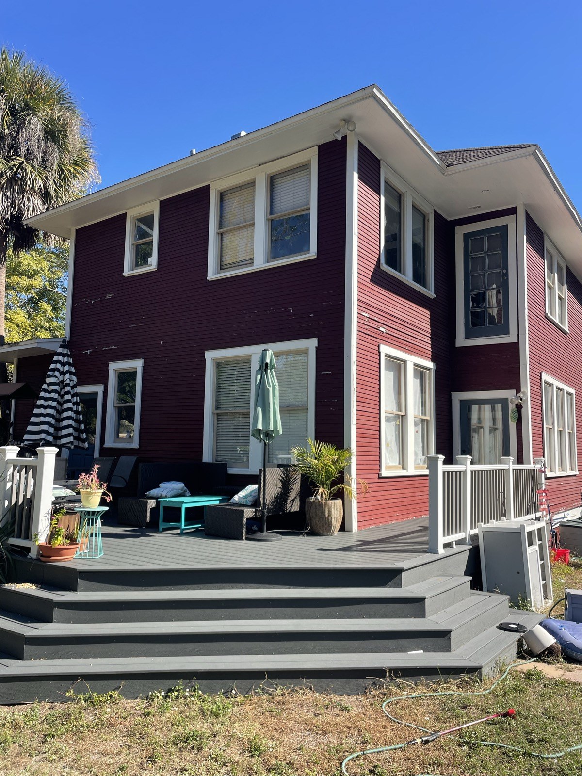 Faded maroon two-story home before repaint