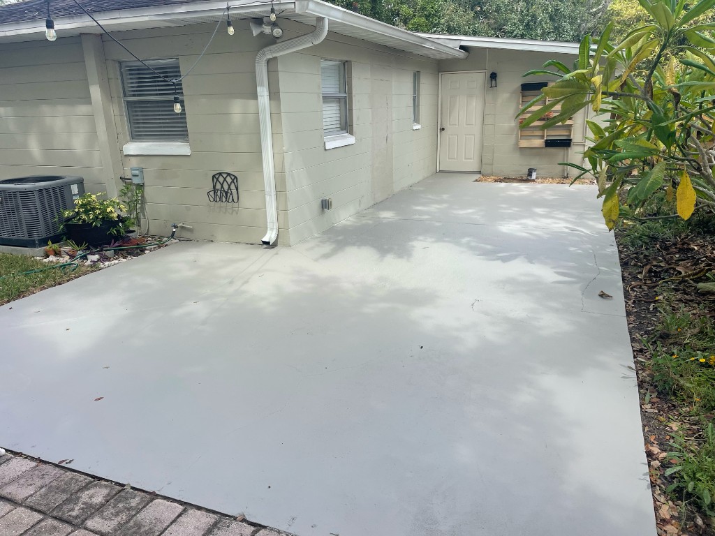 Freshly painted exterior wall and power-washed patio
